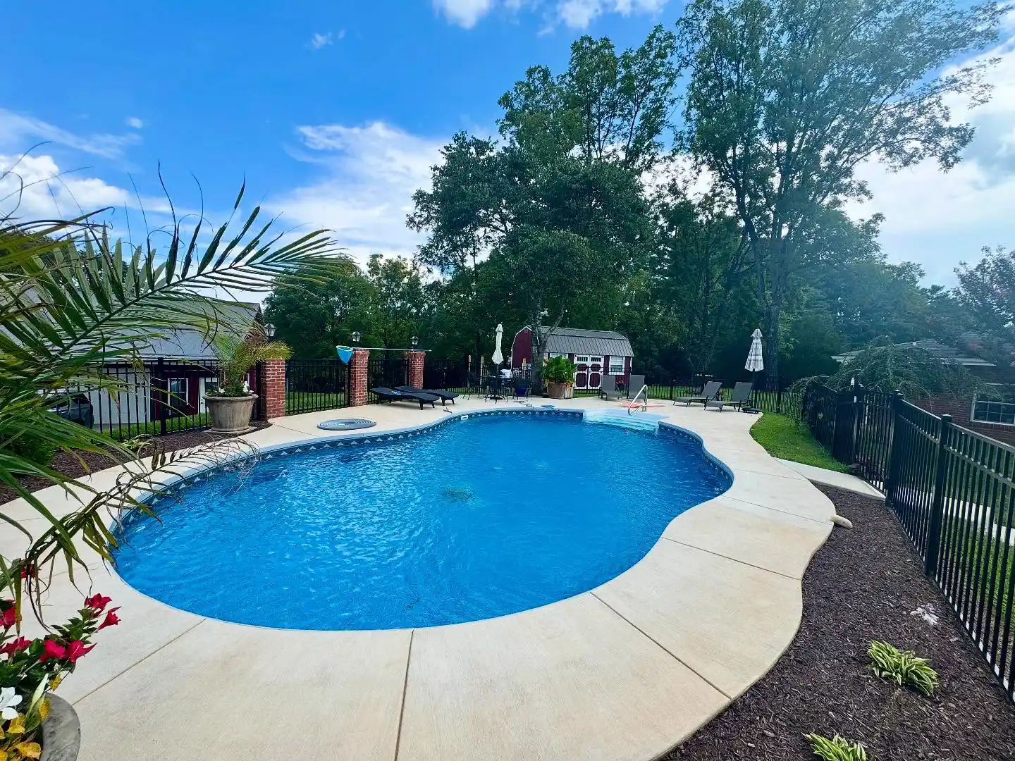 Four-foot black aluminum pool fence enclosing a backyard pool in Daleville, VA